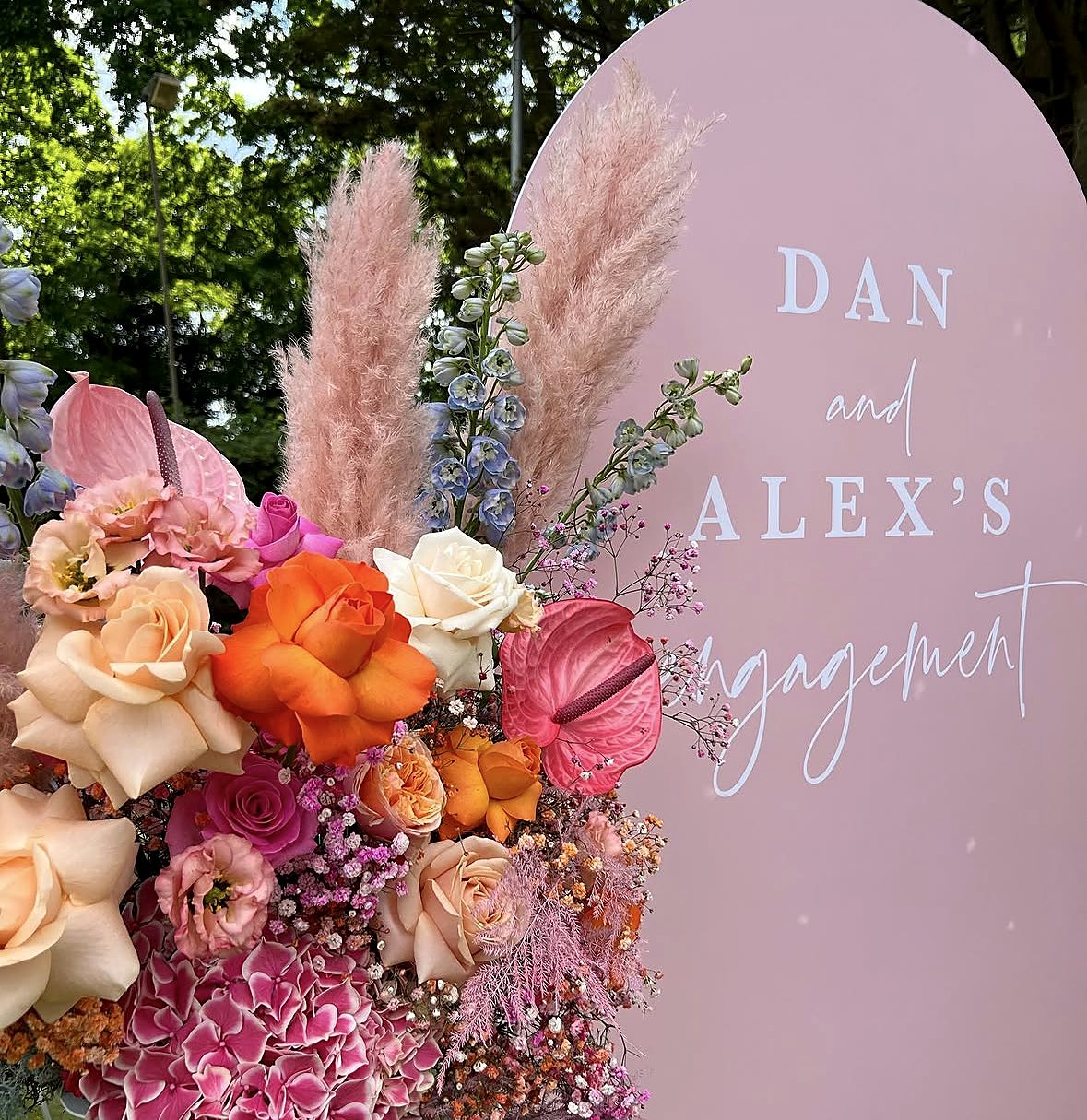 Engagement party sign with pink and orange flowers by Two Little Birds