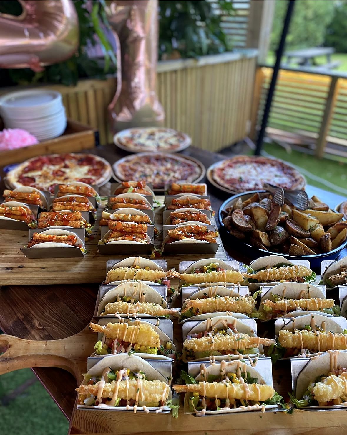 Rows of tempura prawn tacos and halloumi tacos at a party