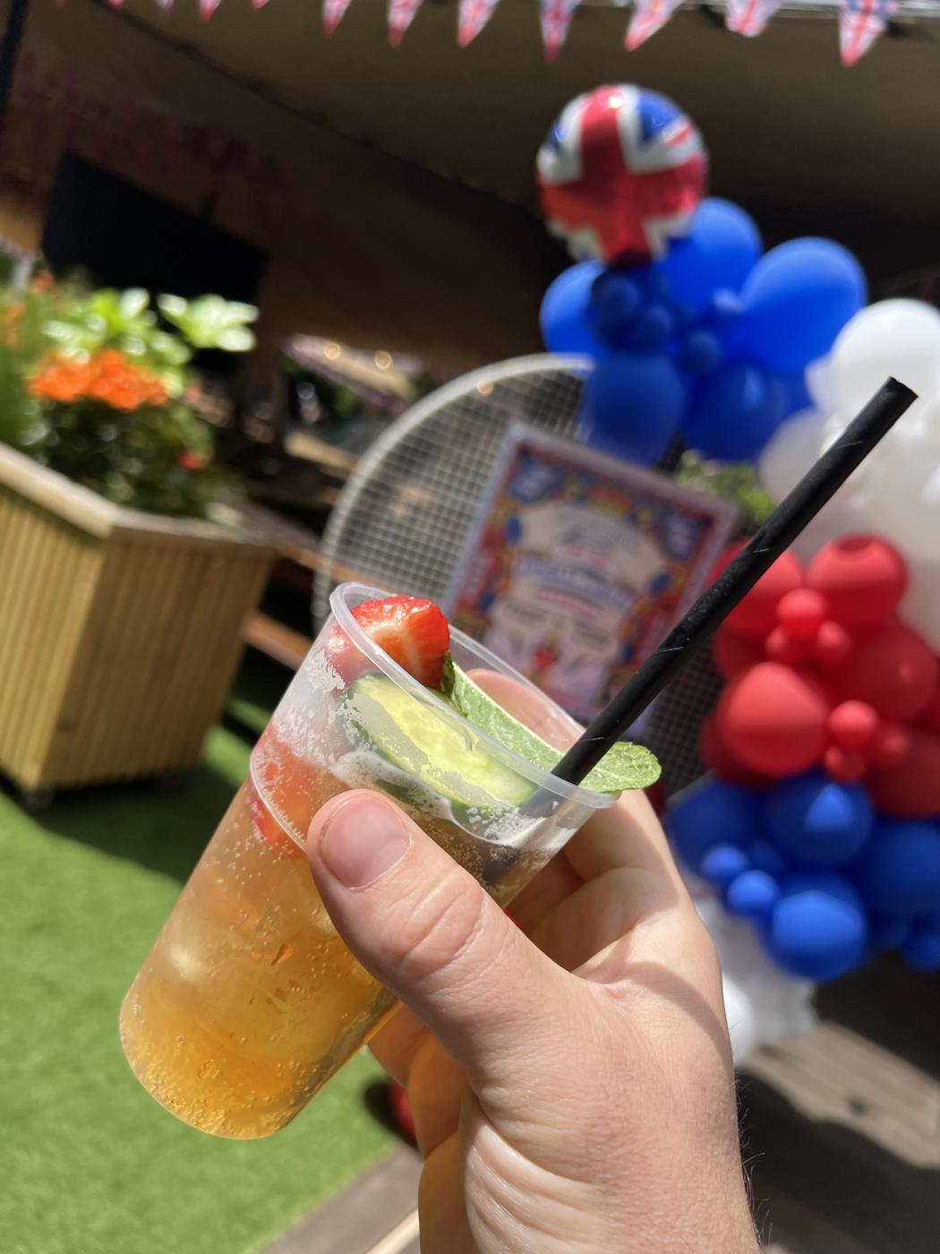 Summer cup with strawberry, cucumber and mint at a garden party